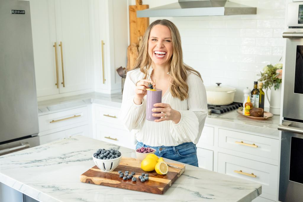 Brigid drinking blueberry smoothie